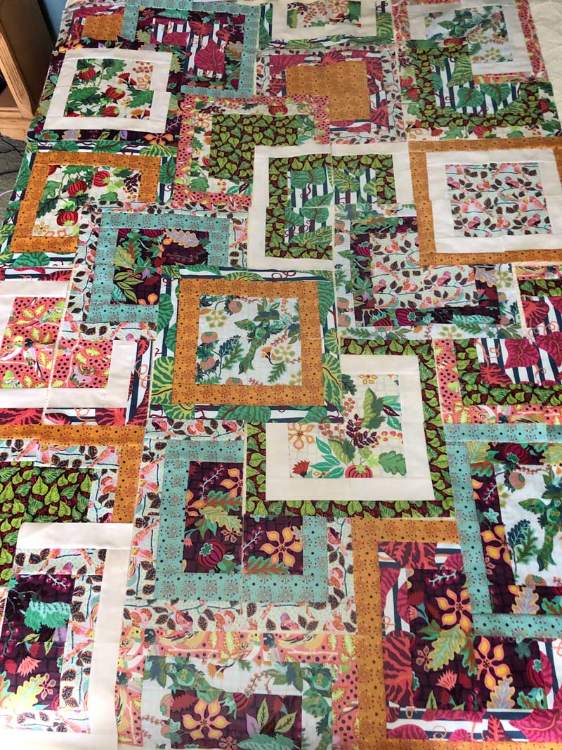 Laying out the completed blocks to finalize the quilt’s design