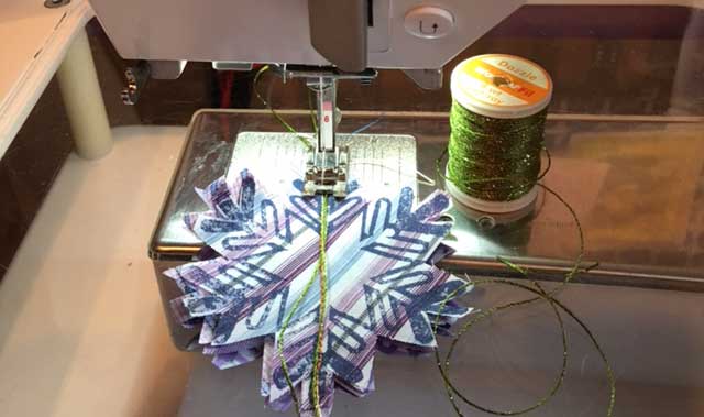 Adding Dazzle thread by WonderFil to stitched fabric snowflake