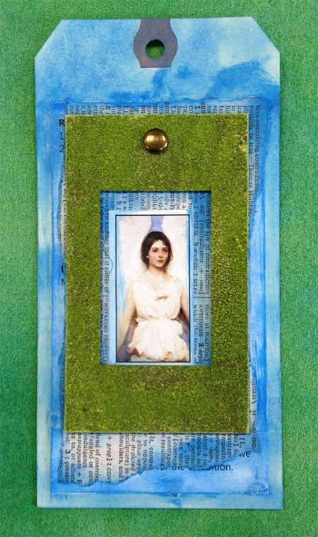 Mixed media tag by Judy Gula with a chipboard frame transformed with Tim Holtz Distressed embossing powder