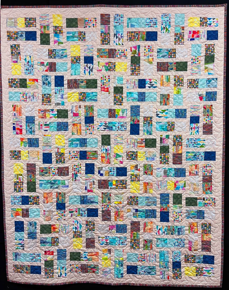 The completed quilt by Christine Vinh using Connections fabric and the Coral quilt pattern