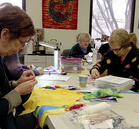 Students at Artistic Artifacts creating their stitched samplers