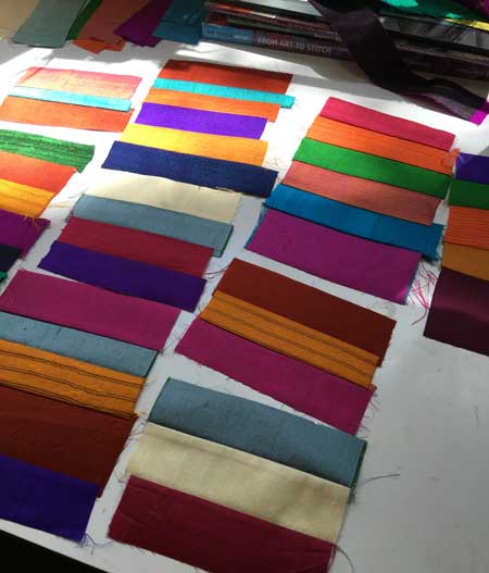 Sari silk strips, cut from fat quarters, in the midst of being chain-stitched for the quilt border